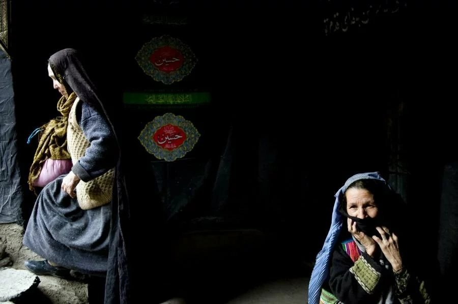 Afghan women sits at the entrance to a Shiite mosque after she received food during Ashura in the streets of Kabul Afghan women sits at the entrance to a Shiite mosque after she received food during Ashura in the streets of Kabul