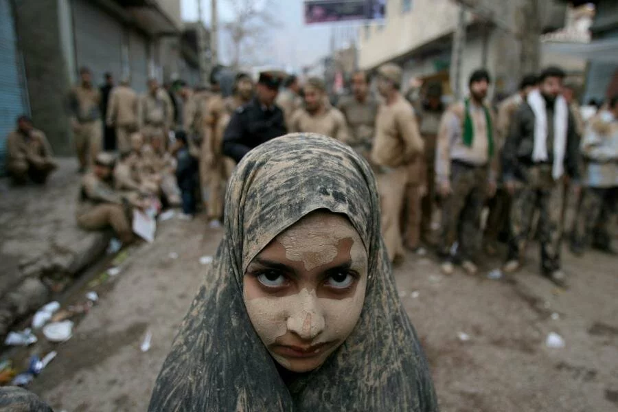 An Iranian girl covered in mud attends the Ashura religious festival in Khorramabad