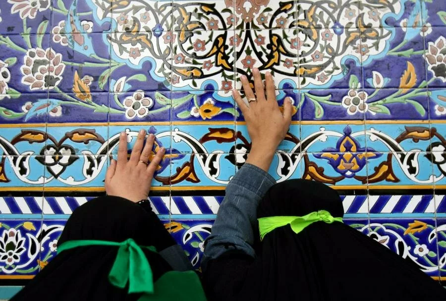 Women wearing chadors pray during an Islamic mourning ceremony called Chehel Menbar (Forty Pulpits) in Western Iran