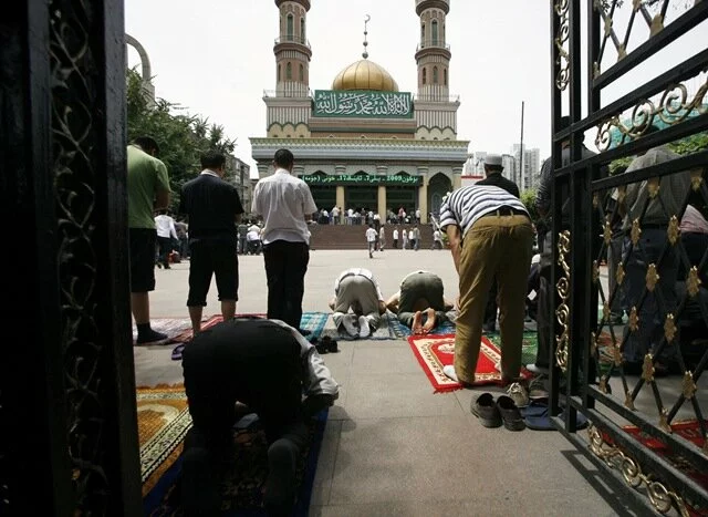 Chinese Muslims pray together during Friday prayers at Yang Hang mosque in the city of Urumqi Chinese Muslims Photo Gallery
