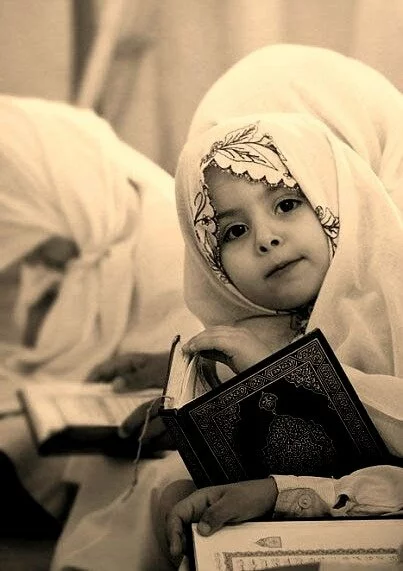 cute muslim baby holding quran