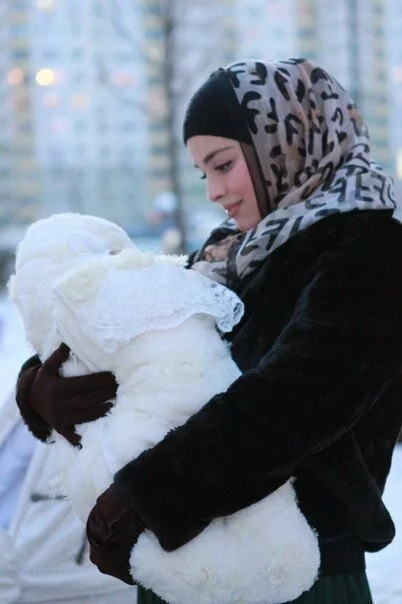 Hijab Women holding her baby
